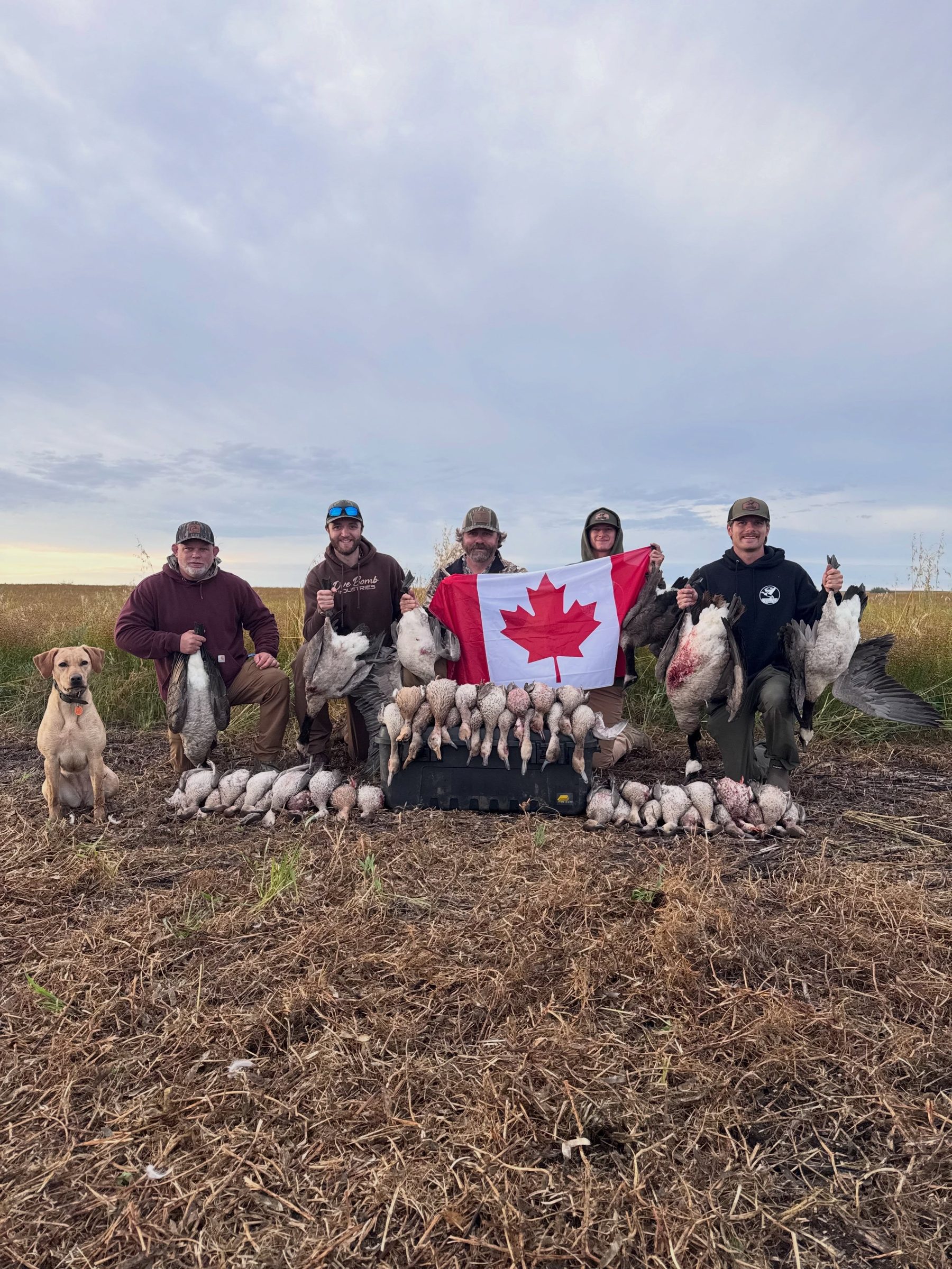 Hunting group with Canadian flag and harvest